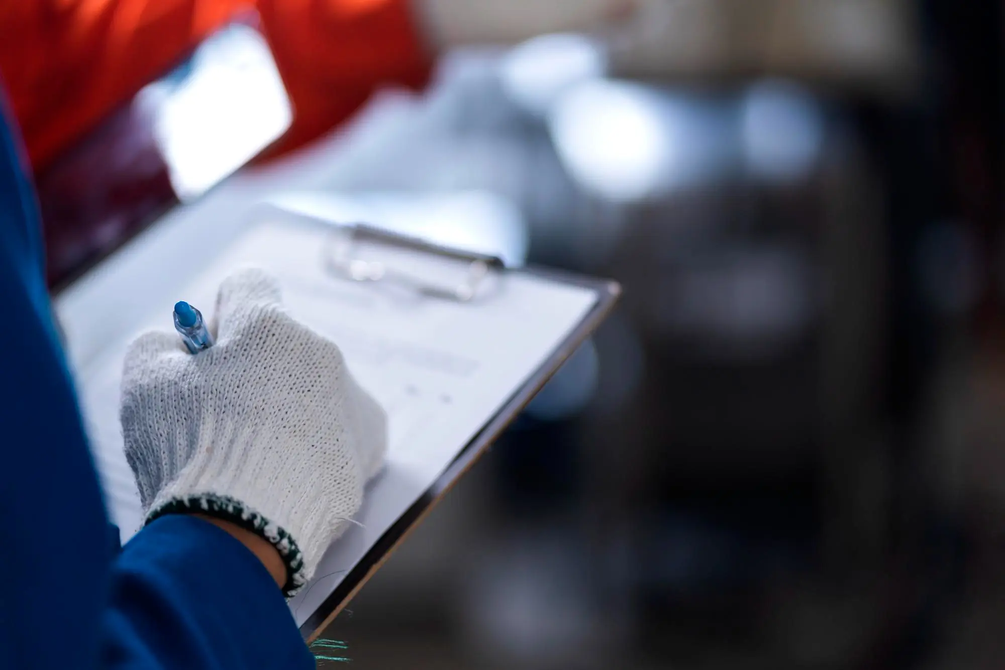 House exterior renovation with workers preparing building materials at a residential construction site